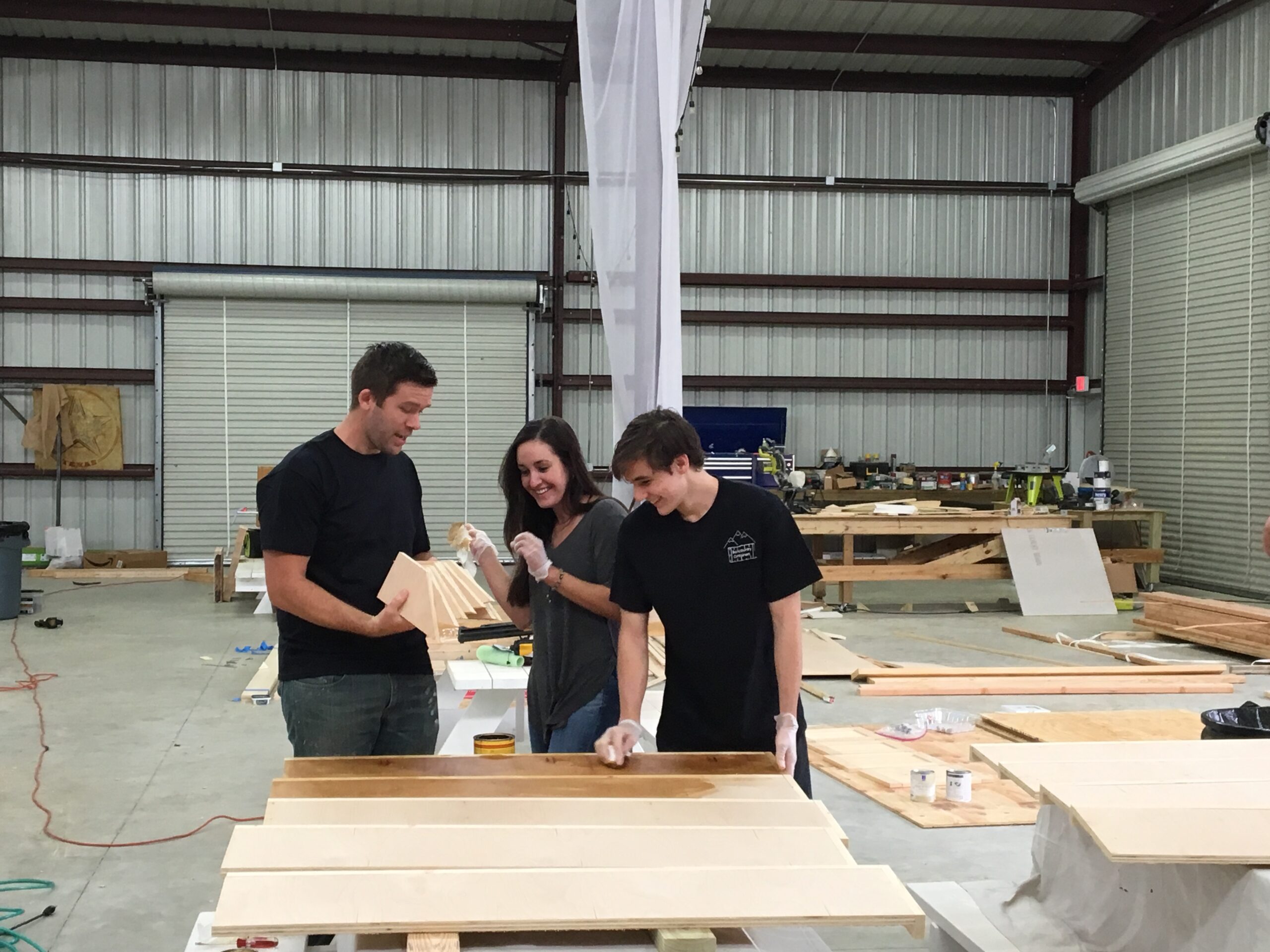 workers making furniture for container home